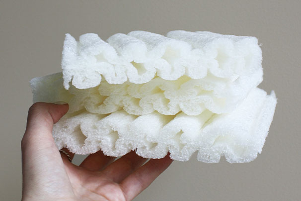 hand holding pieces of biodegradable foam
